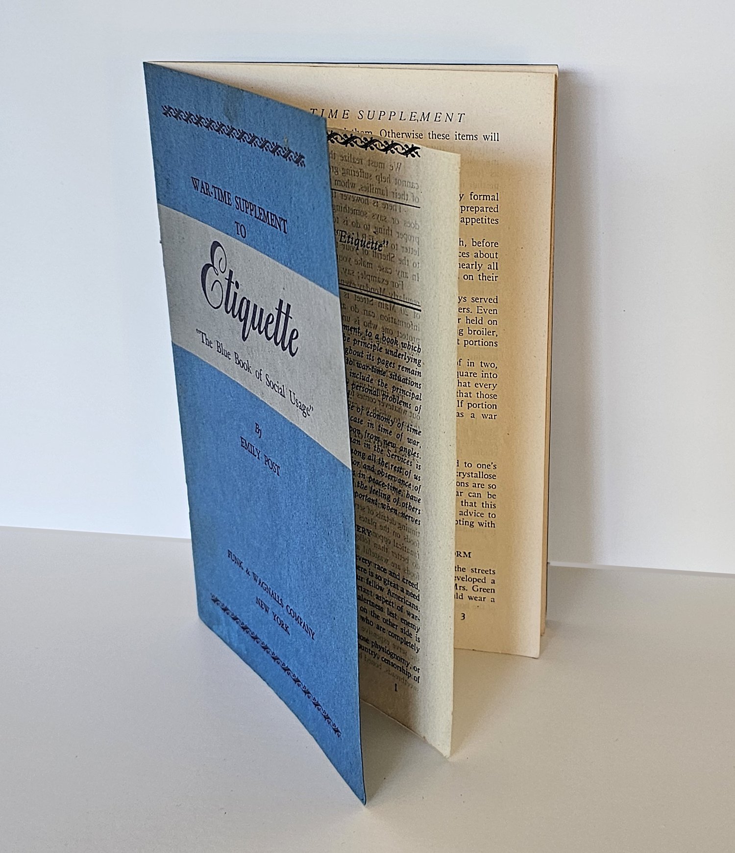 The blue War-Time Supplement booklet standing open with its top edge cleanly trimmed.